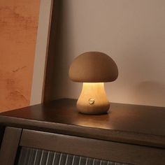 a mushroom lamp sitting on top of a dresser