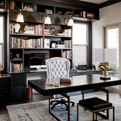 an office with lots of bookshelves and furniture