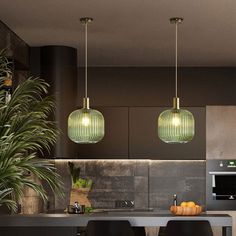 three lights hanging from the ceiling above a kitchen counter