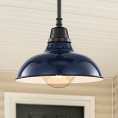 a blue light hanging from the ceiling in front of a door with a black handle