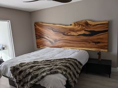 a bed with a wooden head board on top of it