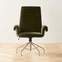 a green office chair sitting on top of a wooden floor