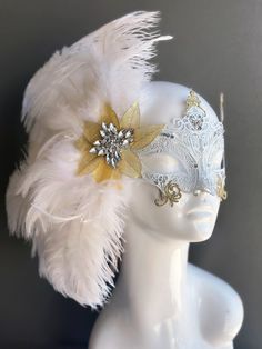 Our women's white laser cut metal masquerade mask, adorned with delicate white feathers and a gold crystal brooch, offers you the opportunity to add a touch of enchanting gold glitter to the mask. Whether you're attending a grand masquerade ball, a themed gala, or simply looking to add a touch of elegance to your attire, this mask ensures you'll be the center of attention.


Age Group/Gender - Adult/Women

Size/Type - One size fits all adults

Mask Color - White

Mask Material - Laser cut metal Elegant White Masquerade Mask For Carnival, Elegant White Masquerade Mask For Mardi Gras, Elegant Feathered Masquerade Mask For Mardi Gras, Elegant Feathered Masquerade Mask, Elegant Feathered Eye Mask For Masquerade, White Masks For Carnival Party, White Party Masks For Carnival, Elegant White Eye Mask, White Carnival Party Mask