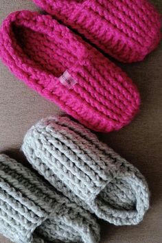 three knitted baby booties sitting next to each other