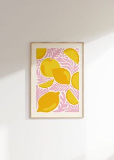 a yellow and pink art piece hanging on the wall