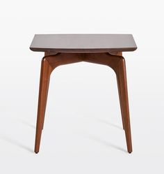 a small wooden table sitting on top of a white floor