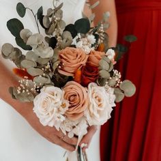 a bride holding a bouquet of flowers in her hands