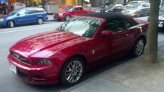 a red sports car parked on the side of the road