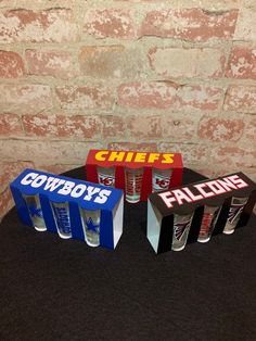 three boxes are sitting next to each other on a black cloth covered tablecloth with a brick wall in the background