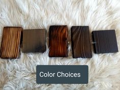 four different colors of wood sitting on top of a white rug