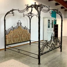 an ornate iron bed frame in a room