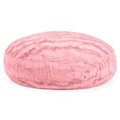 a pink round pillow on a white background