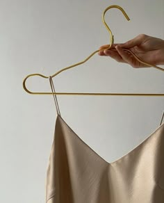 a person is holding onto a clothes hanger