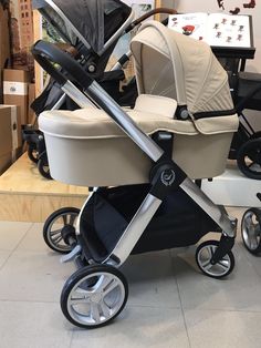 a baby stroller sitting on top of a tile floor