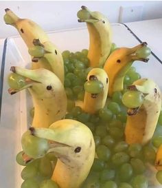 some bananas and grapes with faces drawn on them