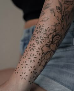 a person with a flower tattoo on their arm