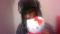 a person wearing a hello kitty hat and holding a wii controller