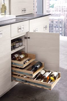 an open drawer in a kitchen next to a counter with spices and condiments