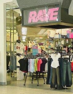 a clothing store with clothes on display in front of the door and sign that says rave