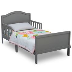 a small child's bed with flowers on the sheets and pillowcase is shown