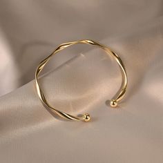 ✦ Our Simple Gold Wave Open Cuff Bangle Bracelet is a dainty and stylish accessory perfect for everyday wear. Crafted from high-quality materials and plated with a shiny gold finish, this bracelet features a unique wave design and an open cuff for comfortable wear. It makes a thoughtful gift for her, best friend or as a couple bracelet. ----------- DESCRIPTIONS ------------ Diameter: 6.2cm- Size: Adjustable - Color: Gold- Materials: Alloy, Gold Plating- SKU: HB637lace for your jewelry) Gold Adjustable Bangle, Minimal Bracelet Gold, Gold Adjustable Bracelet, Elegant Resizable Gold Cuff Bracelet, Minimalist Gold Cuff Bangle, Minimalist Bangle With Simple Design, Minimalist Gold-tone Bangle Bracelets, Bracelet Product Photography, Gold Minimalist Cuff Bracelet, Gold Plated