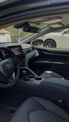 the interior of a car with black leather seats and dashboards, including an electronic display