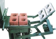 three brick making machine with four red bricks