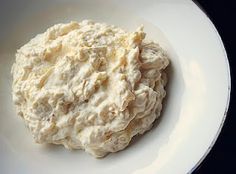 a white bowl filled with food on top of a table