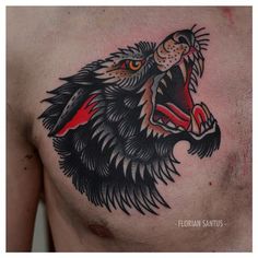 a man's chest with a tattoo of a wolf on the side and his mouth open