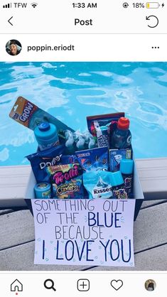 a box filled with items next to a swimming pool that says something out of the blue because i love you