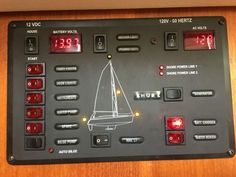 the control panel for a sailboat is marked with red lights and numbers on it