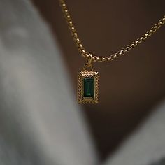 Featuring our signature emerald gemstones and textured border, the 'Emerson' necklace effortlessly combines timeless elegance with a modern edge, making it the perfect accessory to elevate any ensemble. Whether worn for a special occasion or as a statement piece for everyday wear. All of our 18k gold or silver plated jewellery should be stored in a cool, dry place and cleaned carefully with a soft non-abrasive cloth to maintain shine.  Our pieces also contain real glass stones, cubic zirconia or Vintage Emerald Necklace, Emerald And Gold Jewelry, Gold Jewelry With Stones, Gold And Emerald Necklace, Emerald Gold Jewelry, Cool Pendants, Emerald Gold Necklace, Emerald Necklace Gold, Gold Green Necklace