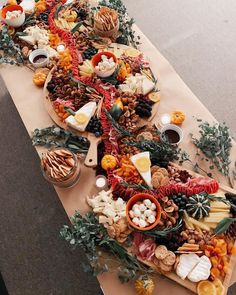 a table topped with two pizzas covered in different types of toppings and vegetables