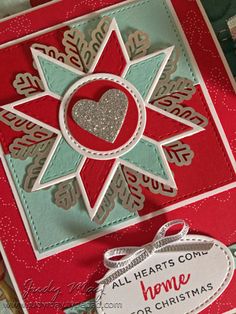 a christmas card with a heart and snowflake