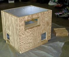 a wooden box sitting on top of a tarp covered floor