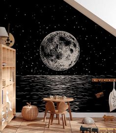 a child's room decorated in black and white with an image of the moon