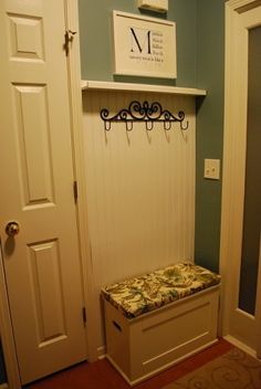 an entryway with a bench and coat rack