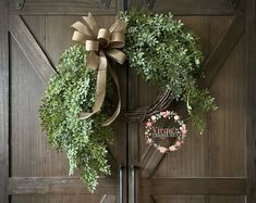 a wreath with a bow hanging on the front door to give it a special touch