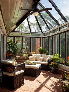 a sun room with lots of windows and furniture