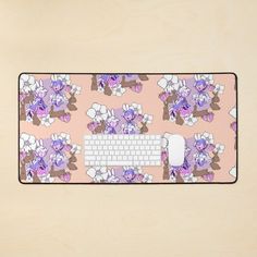 a computer keyboard and mouse pad with flowers on it