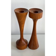 two wooden candlesticks sitting next to each other