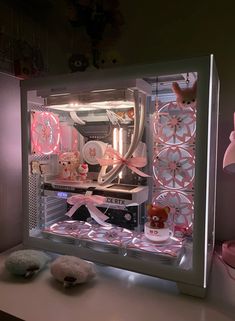 the inside of a computer case is decorated with pink and white decorations, including teddy bears