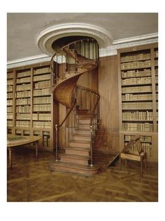 a spiral staircase in the middle of a library