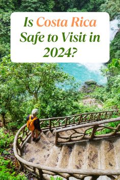 a woman standing on top of a wooden bridge in the forest with text overlay saying is costa rica safe to visit in 202