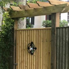 a wooden gate with a clock on it