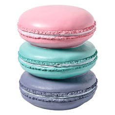 three macaroons stacked on top of each other in different colors and shapes,