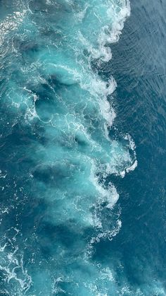 the water is very blue and green with white foamy waves on it's sides