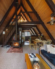 an attic living room with wood paneling and a fireplace