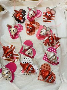 some little mouses are made out of heart shaped paper and have bows on them