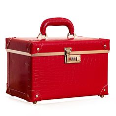 a red suitcase with gold trim and handles